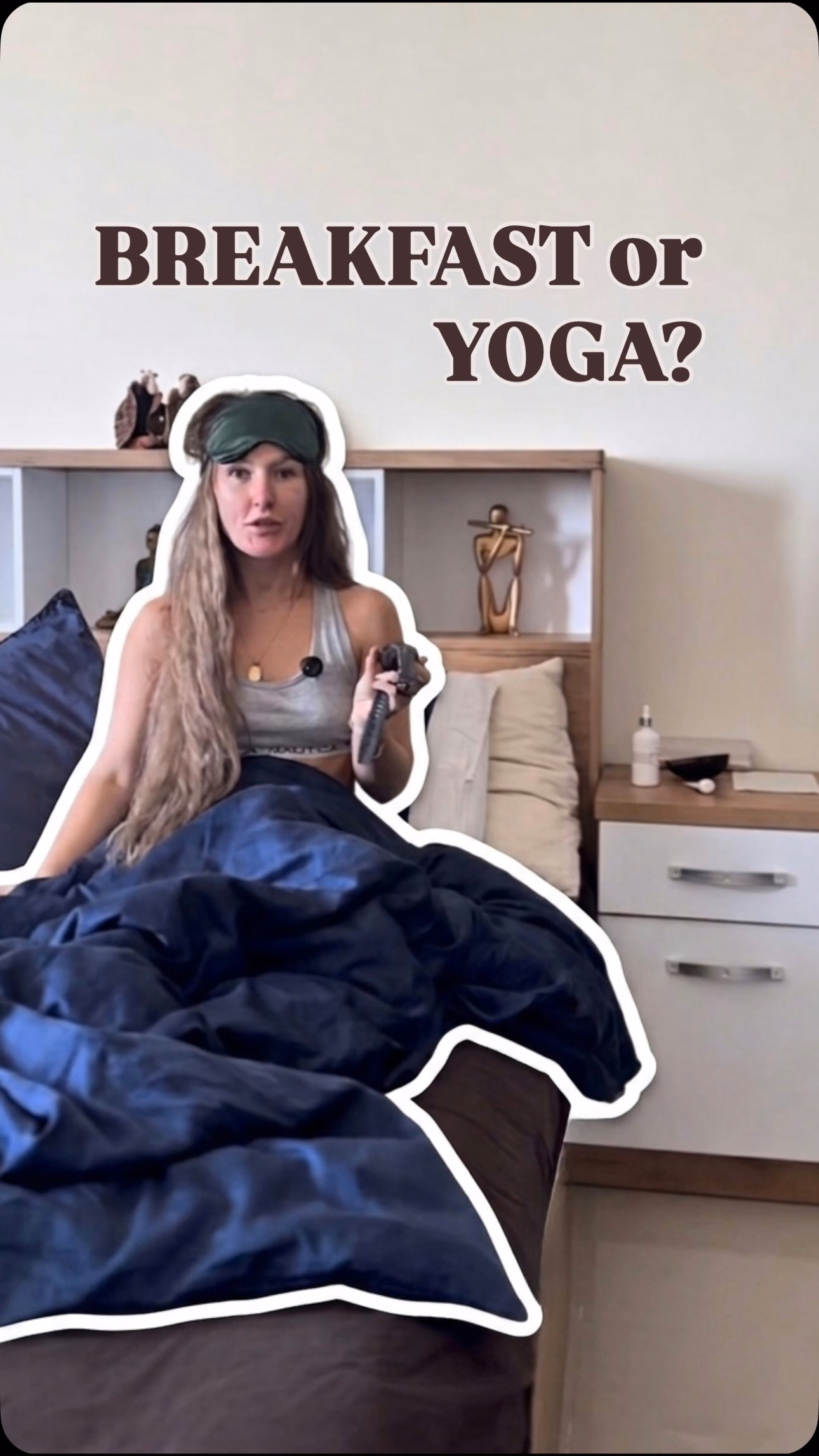 Woman sitting in bed under a navy duvet with the overlay Breakfast or Yoga