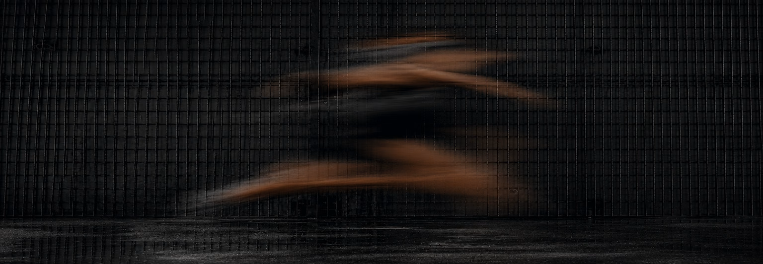 Motion-blurred runner in a dark industrial setting